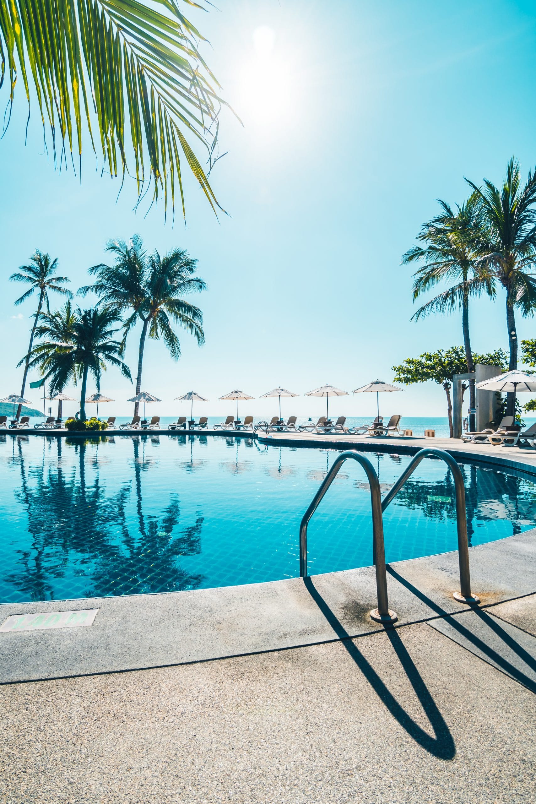 מידע מקצועי 10 beautiful tropical beach sea with umbrella chair around swimming pool scaled